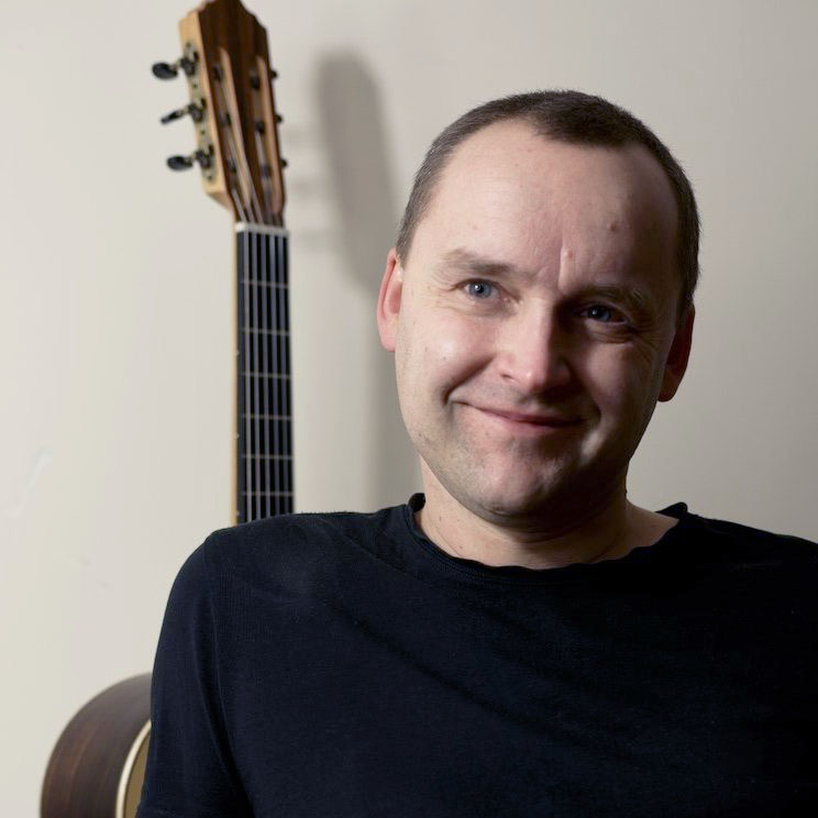 Krzysztof Mrozowski, doradca Lutniczego Outletu, obok gitary klasycznej